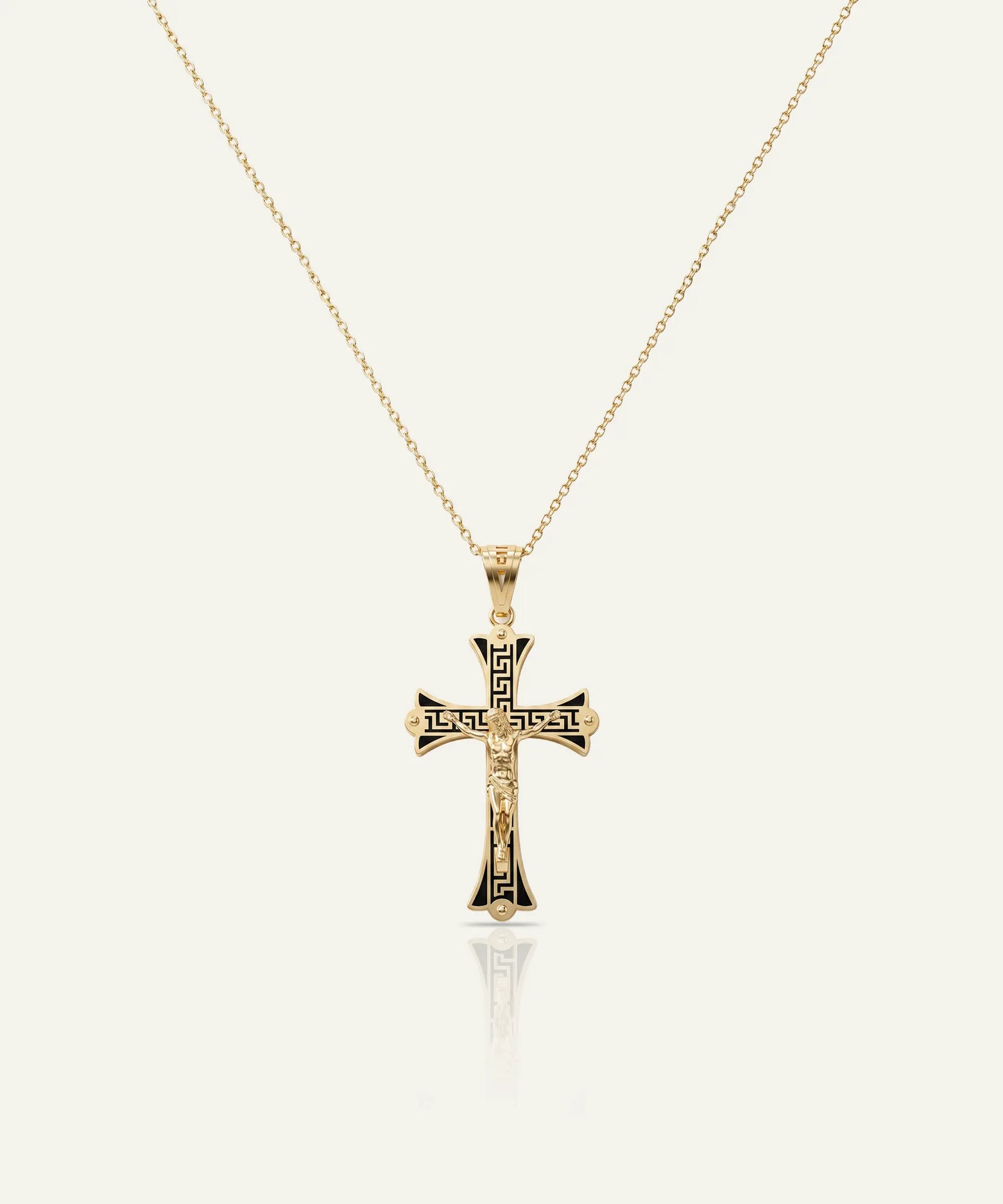 Gold cross pendant necklace on a white background