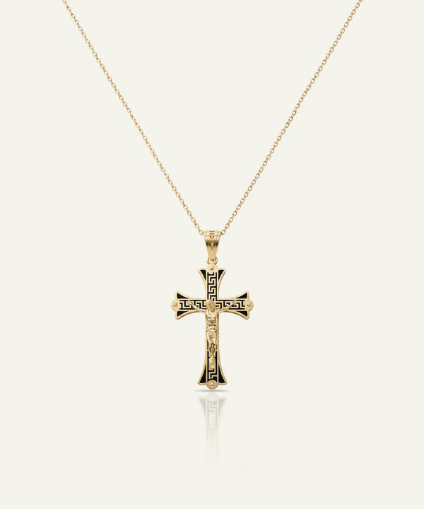 Gold cross pendant necklace on a white background