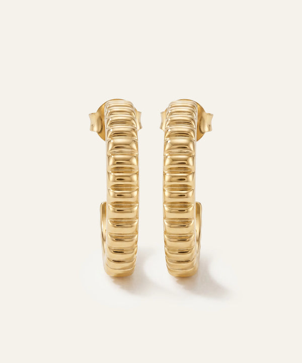 Gold hoop earrings on a white background