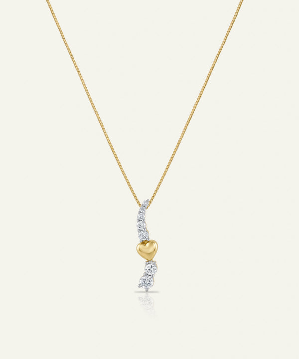 Gold necklace with a heart-shaped pendant and diamond accents on a white background