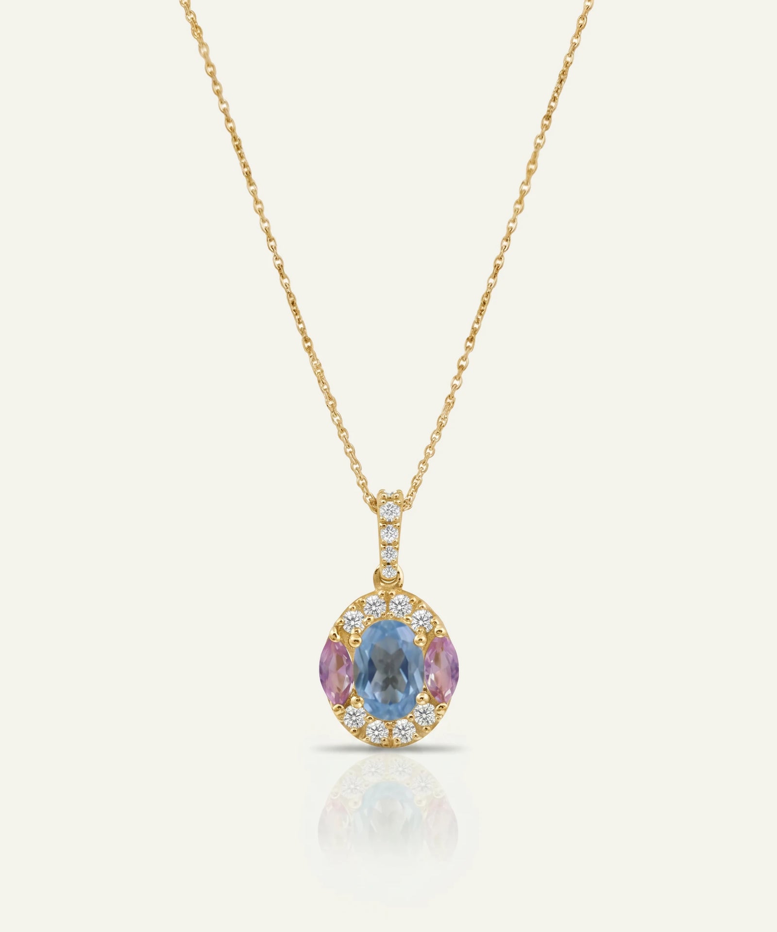 Gold necklace with a multicolored gemstone pendant on a white background