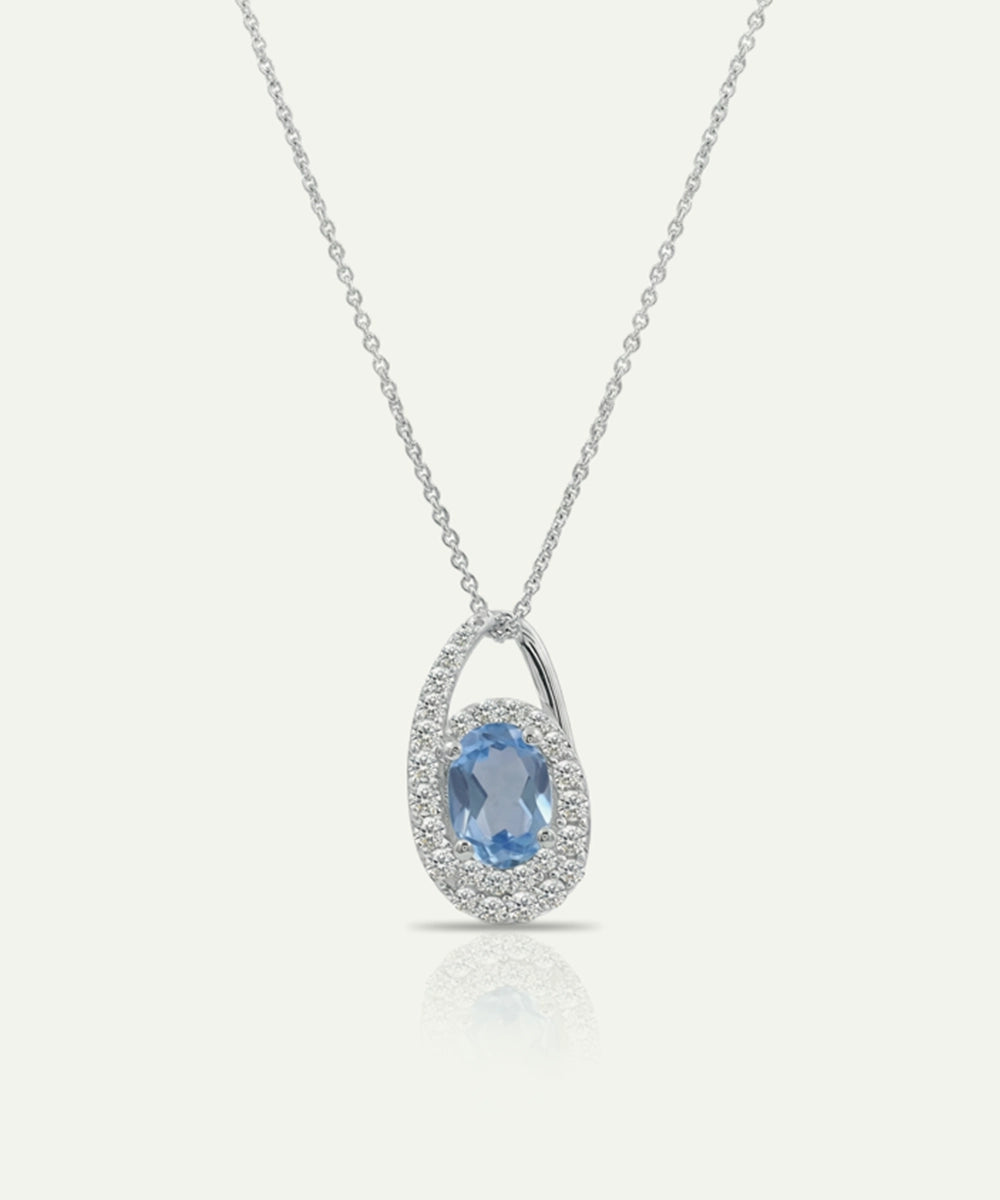 Silver pendant with a blue gemstone on a white background