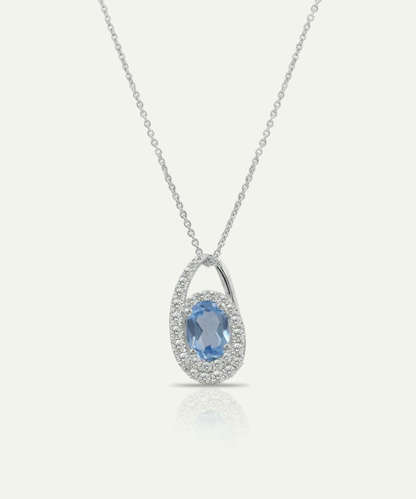 Silver pendant with a blue gemstone on a white background