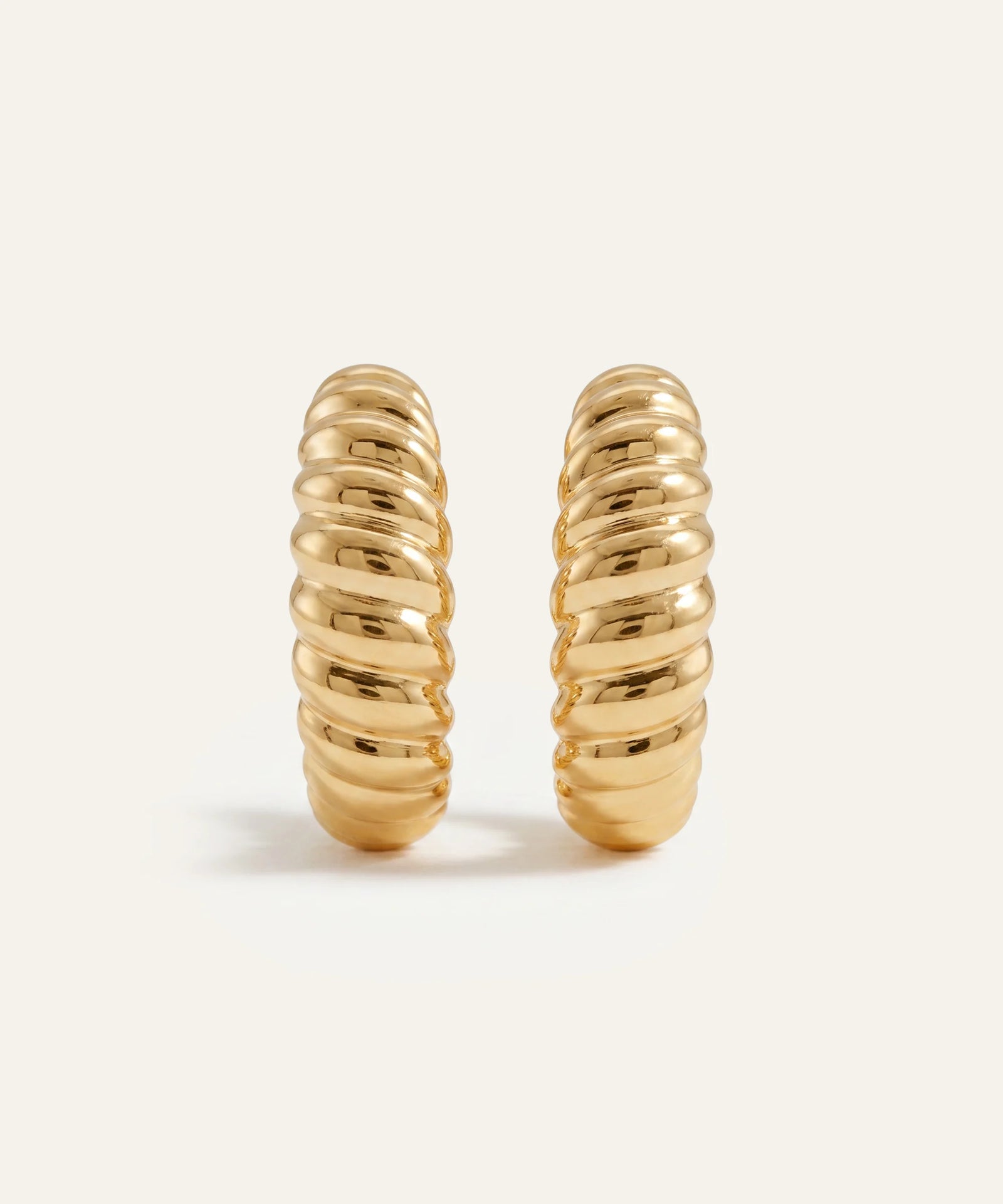 Pair of gold hoop earrings on a white background