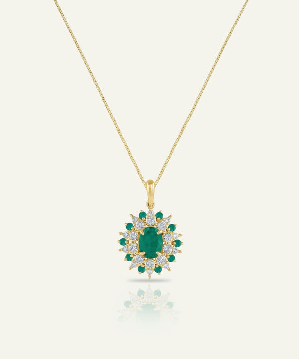 Gold necklace with a green gemstone pendant on a white background