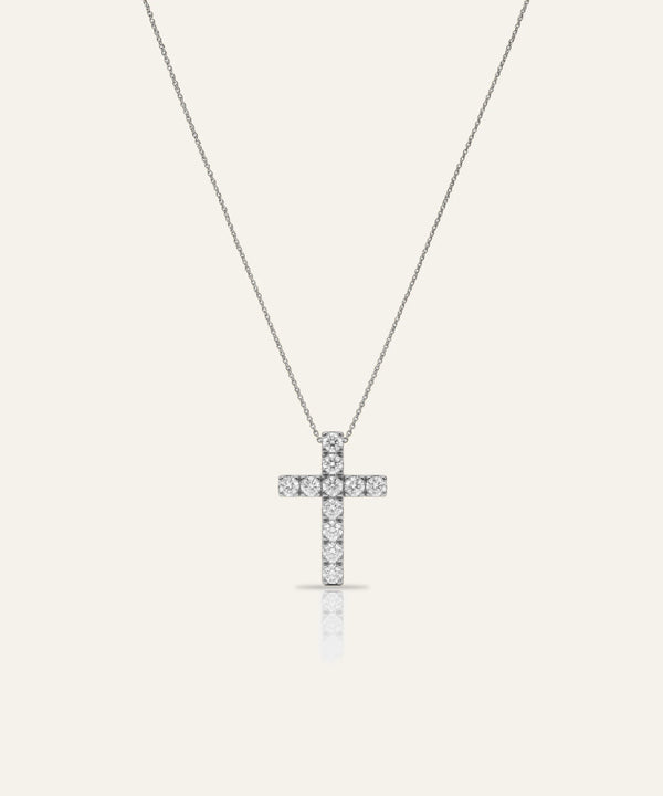 Cross-shaped pendant necklace on a white background