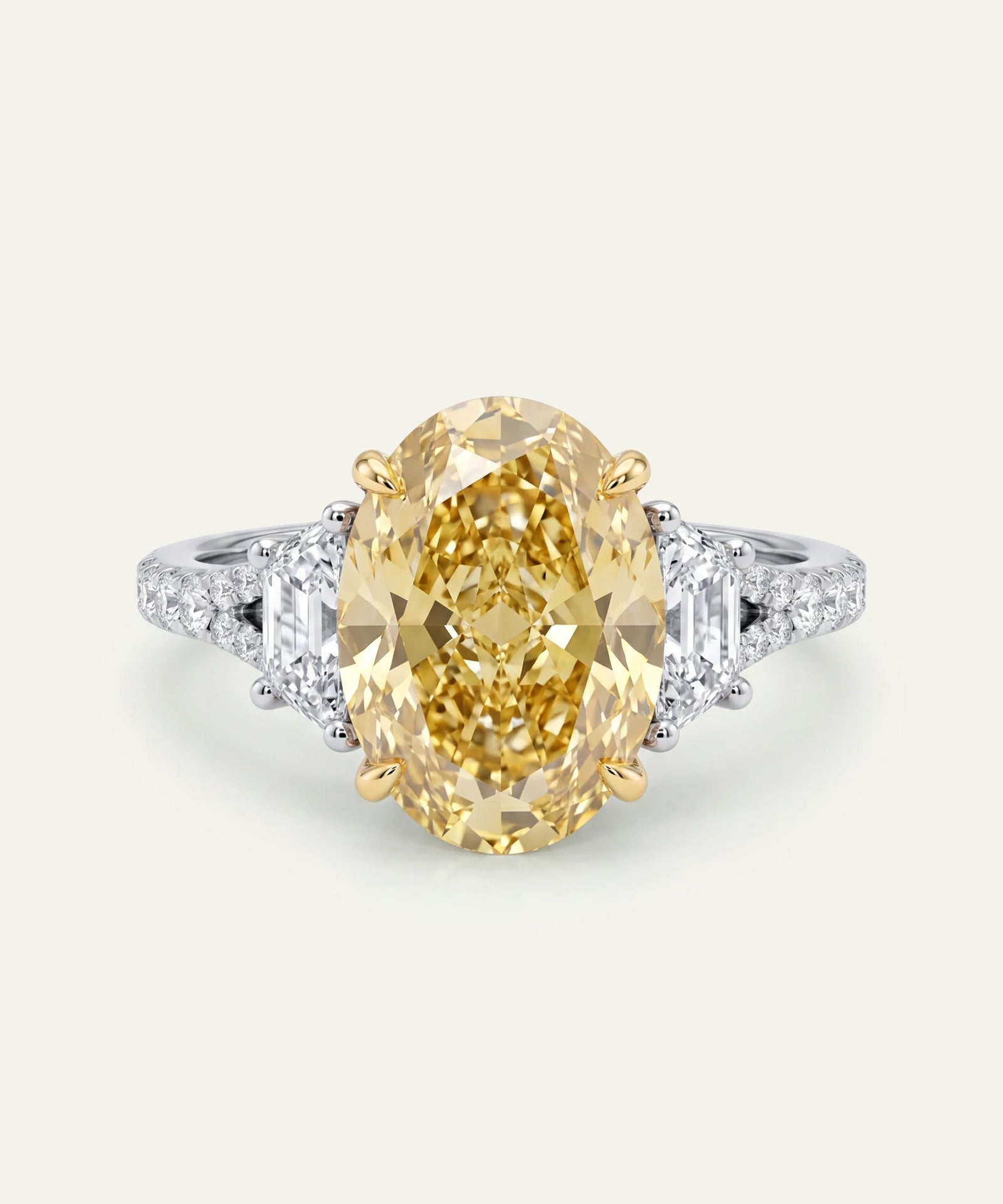 Gold ring with a large yellow gemstone on a white background