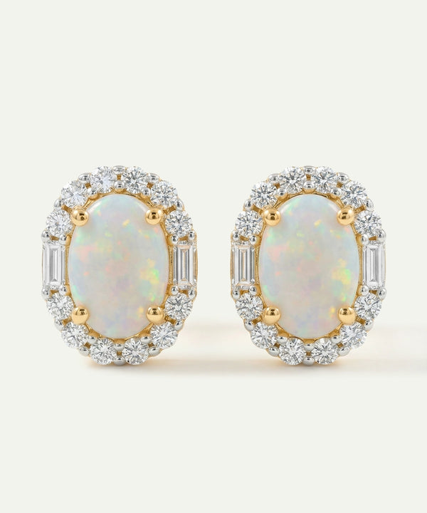 Pair of opal earrings with gold and diamond accents on a light background
