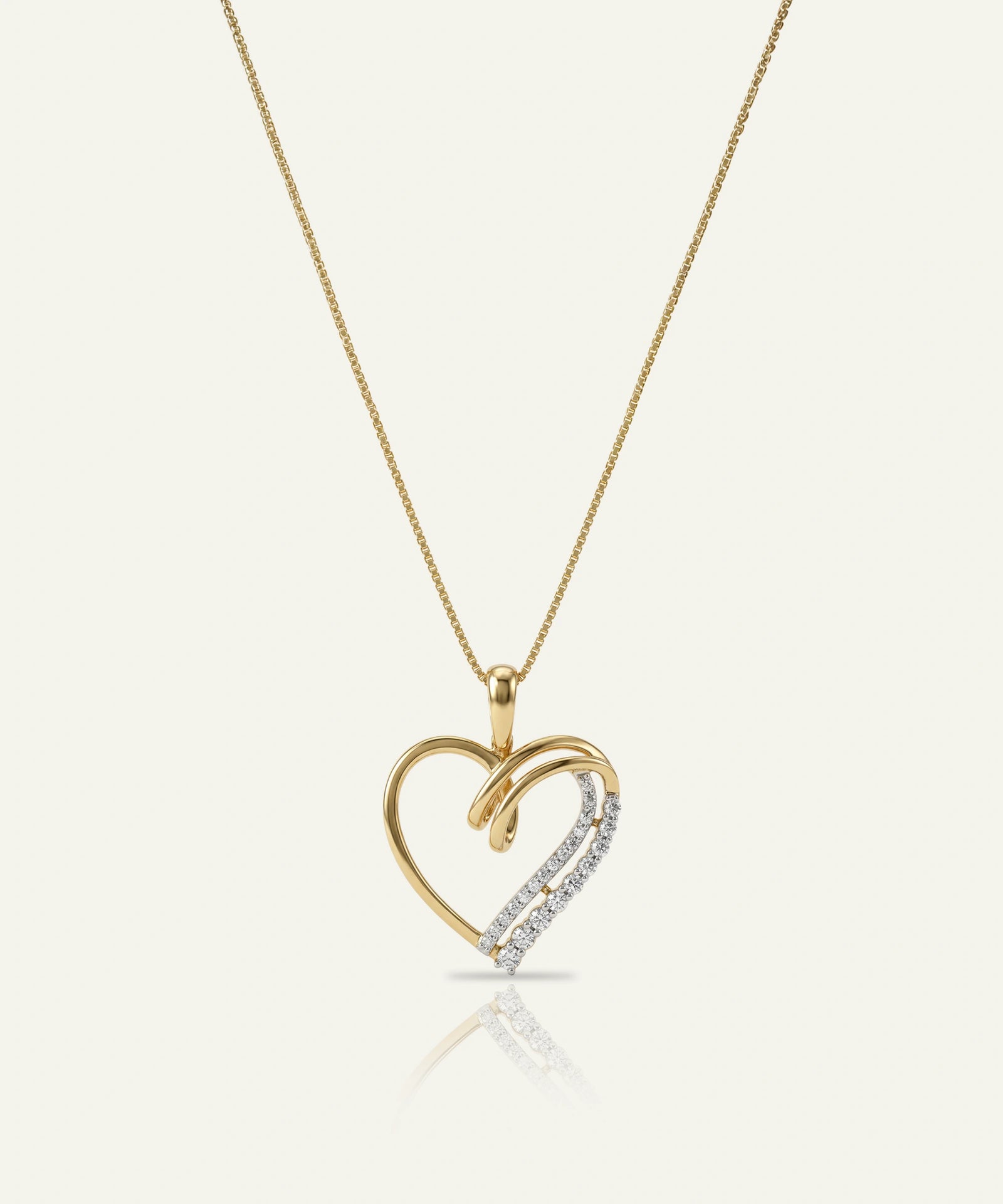Gold heart-shaped pendant necklace on a white background