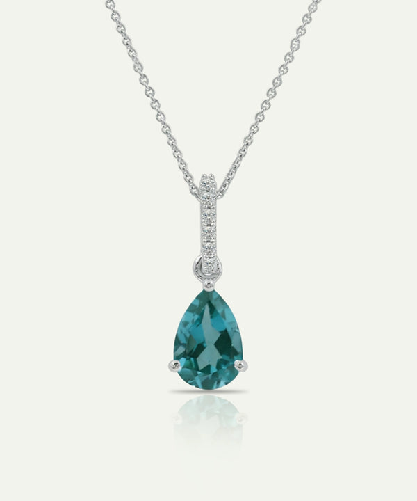 Teardrop-shaped blue gemstone necklace with chain on a white background