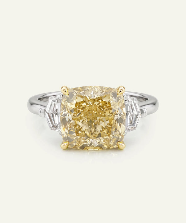 Diamond ring with a yellow gemstone on a white background