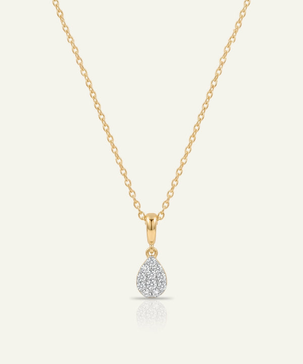 Gold necklace with a teardrop-shaped diamond pendant on a white background