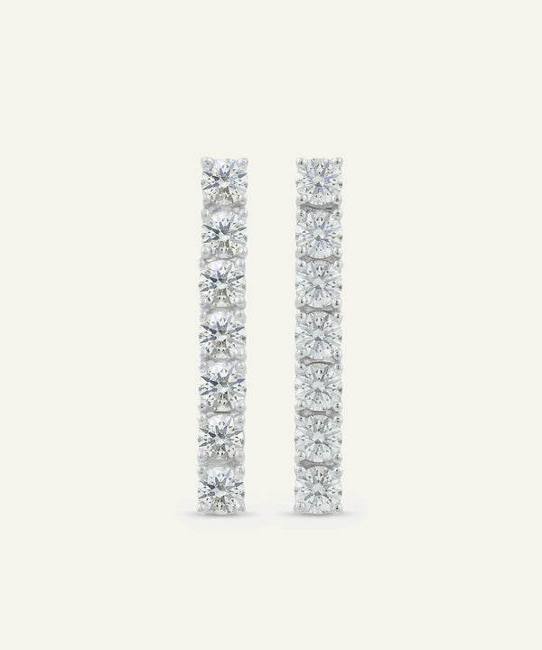 Pair of diamond earrings on a light gray background