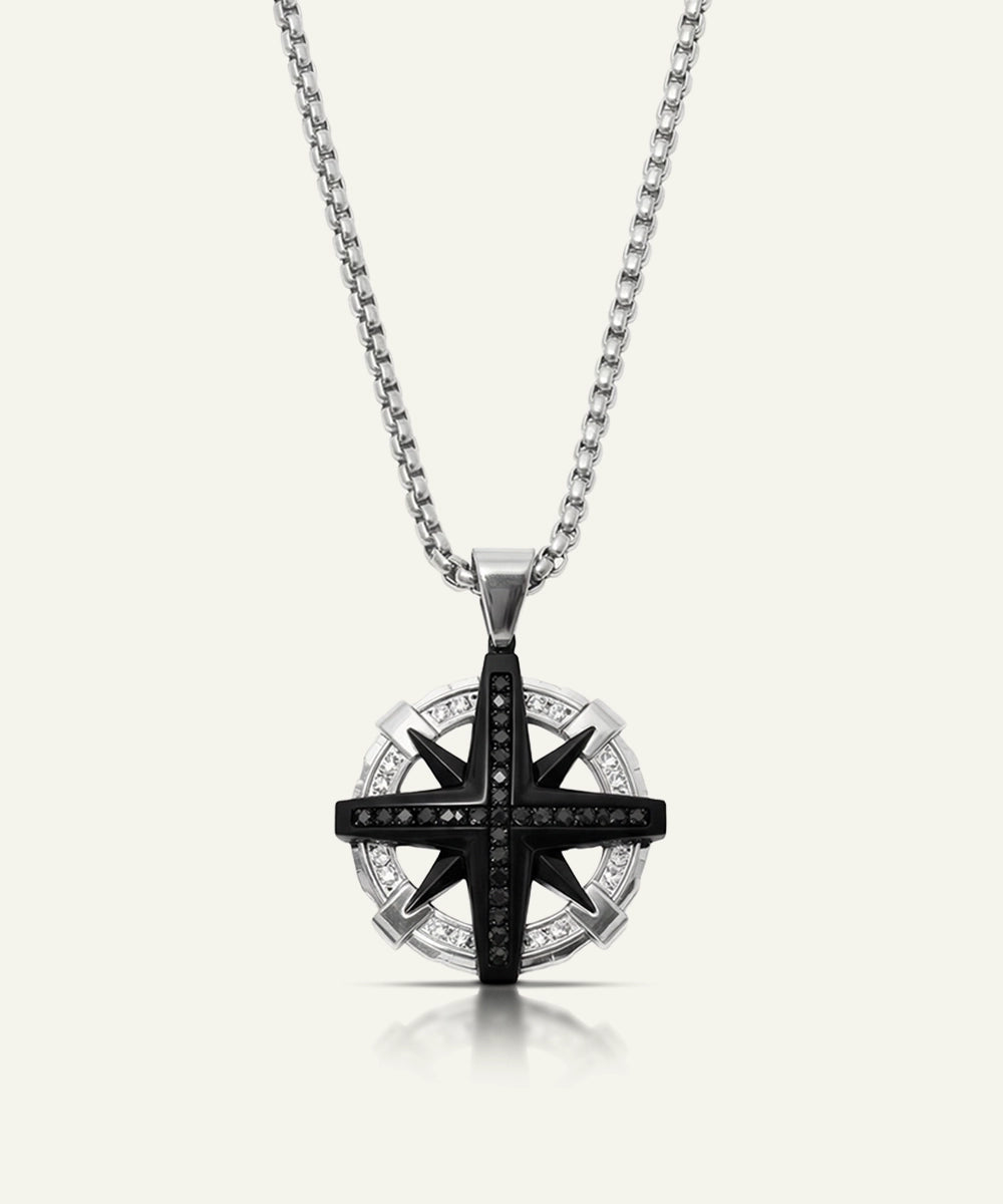 Star-shaped pendant necklace with black and clear stones on a white background