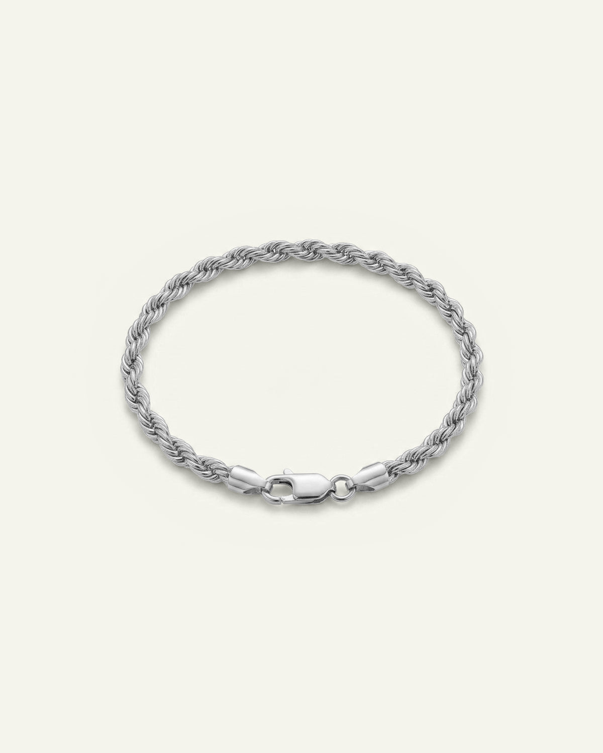 A silver rope chain bracelet with a lobster clasp, displayed on a light cream background.