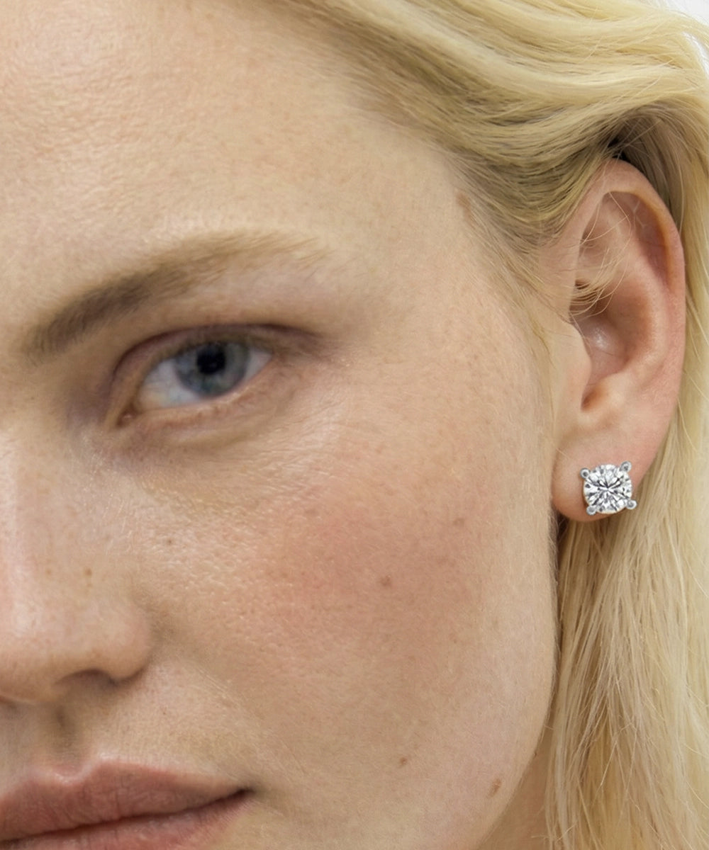 Close-up of a woman wearing a diamond earring.