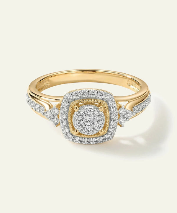 Gold ring with diamond accents on a light beige background