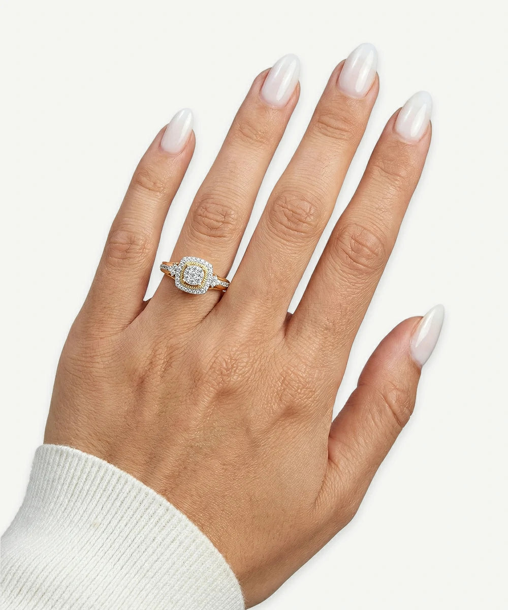 Hand wearing a diamond ring on a white background