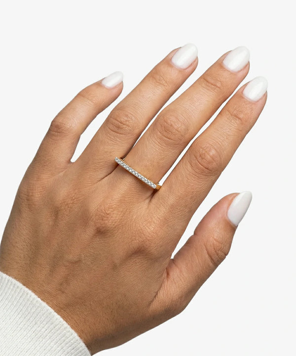 Hand wearing a silver ring with a white background