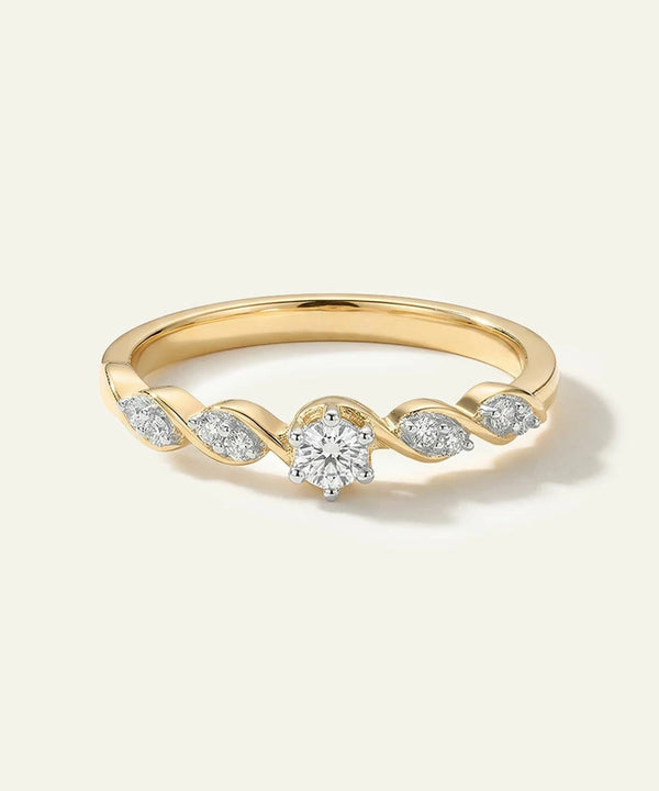 Gold ring with diamonds on a light gray background