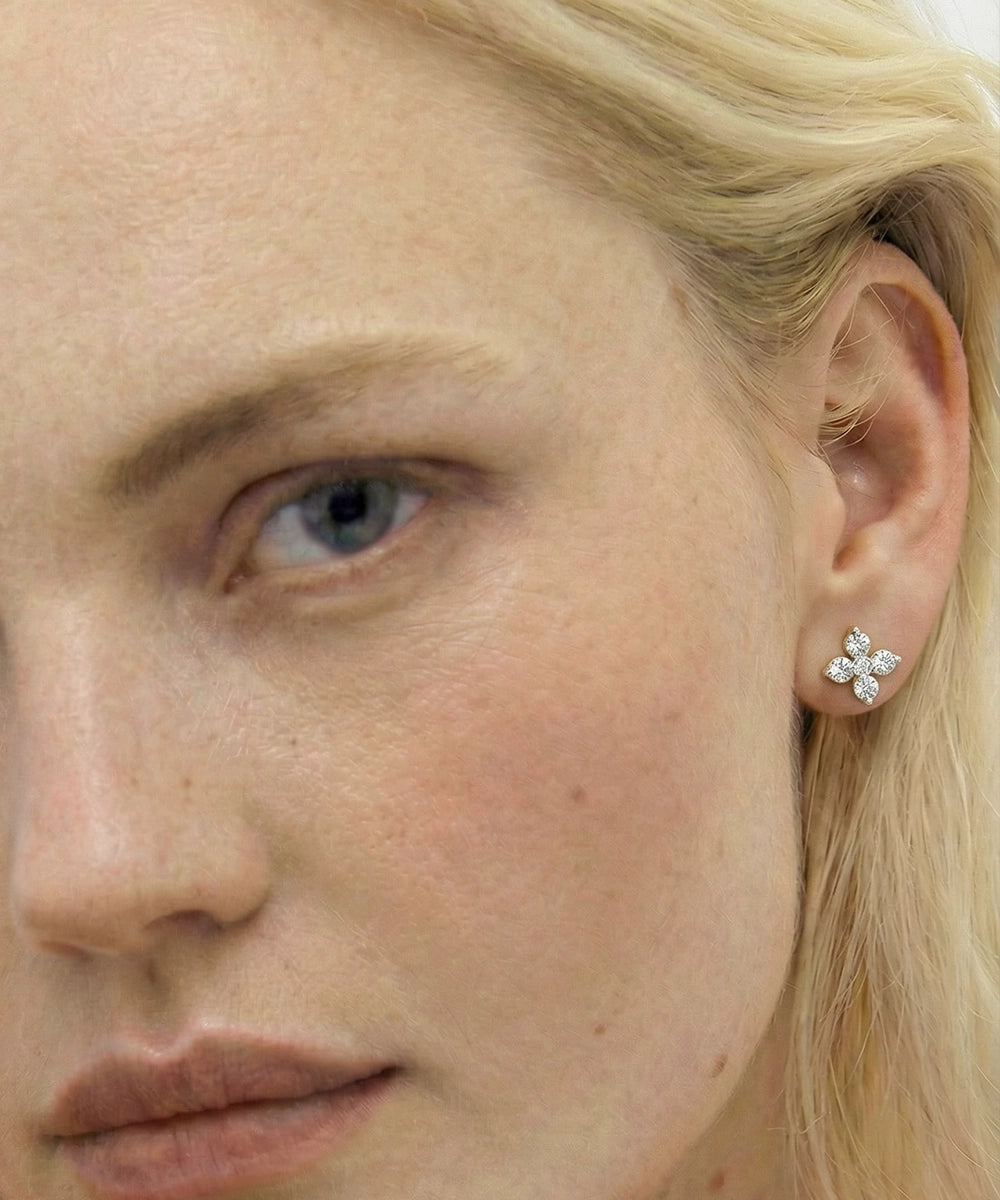 Close-up of a person wearing a diamond earring