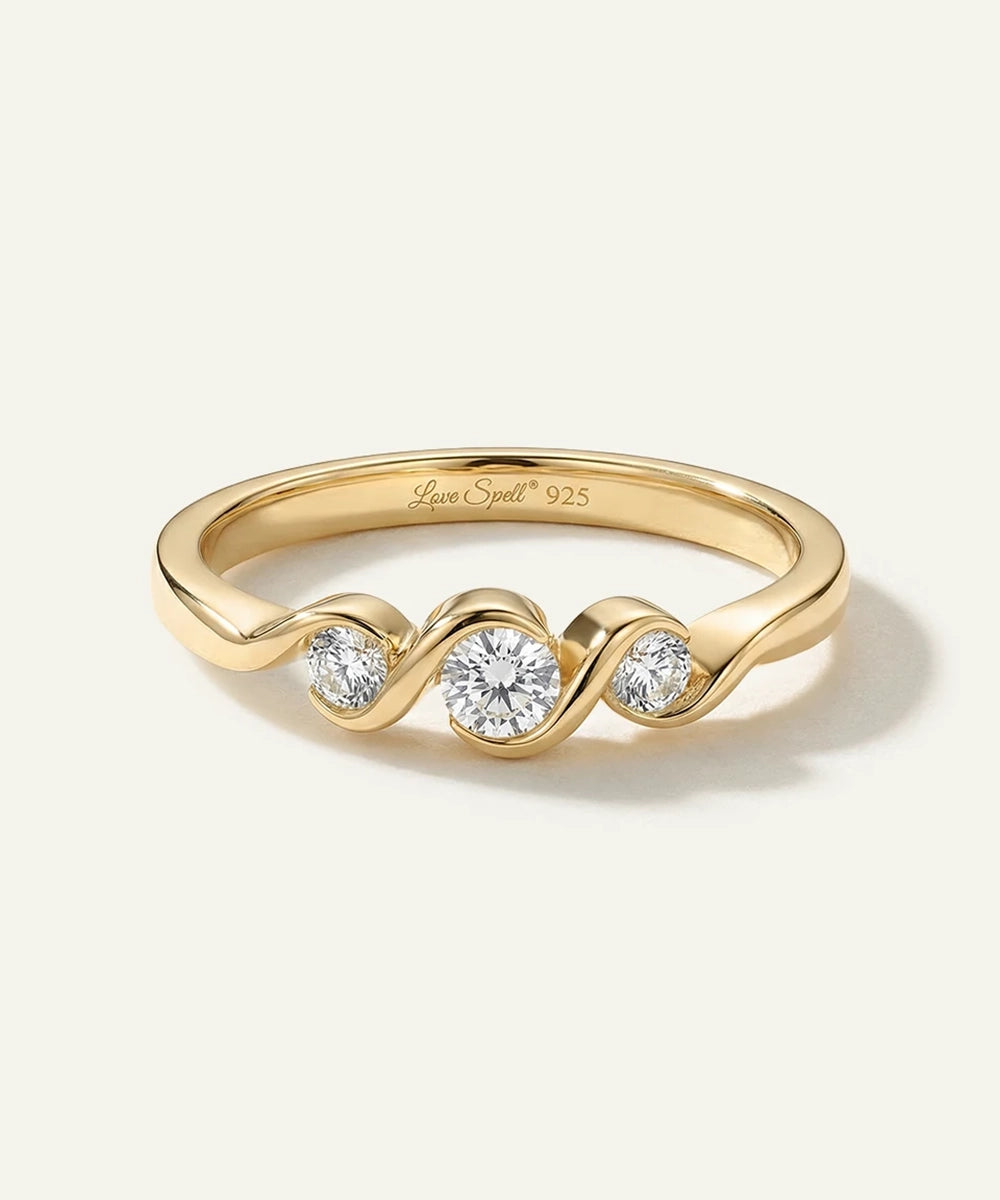 Gold ring with three diamonds on a white background