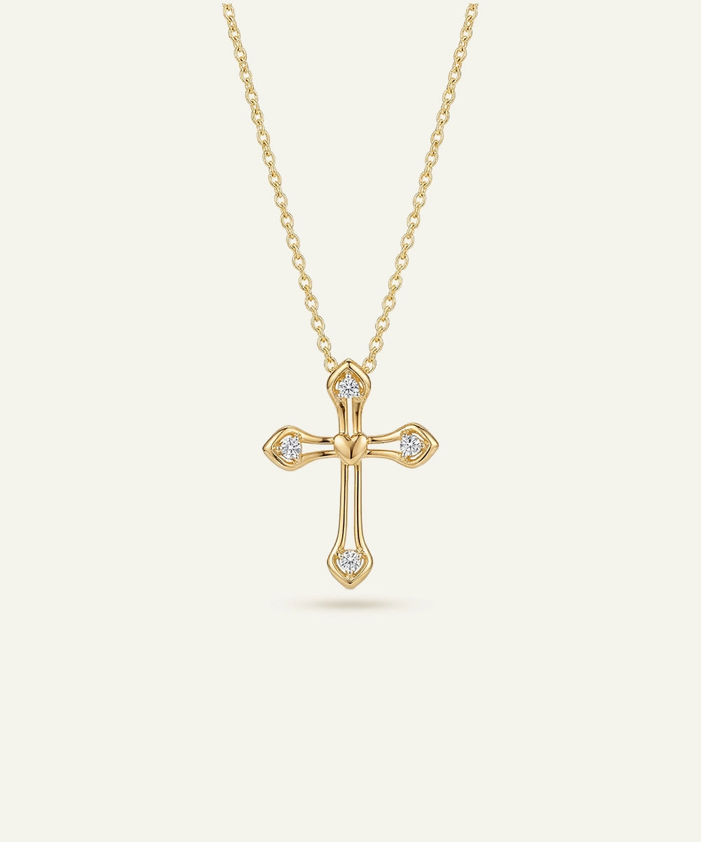 Gold cross necklace with diamonds on a white background