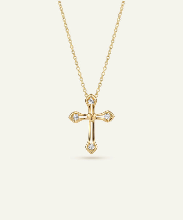Gold cross necklace with diamonds on a white background