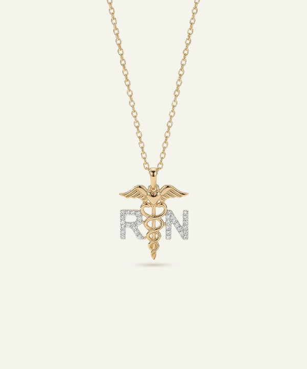 Gold necklace with a medical symbol pendant on a white background