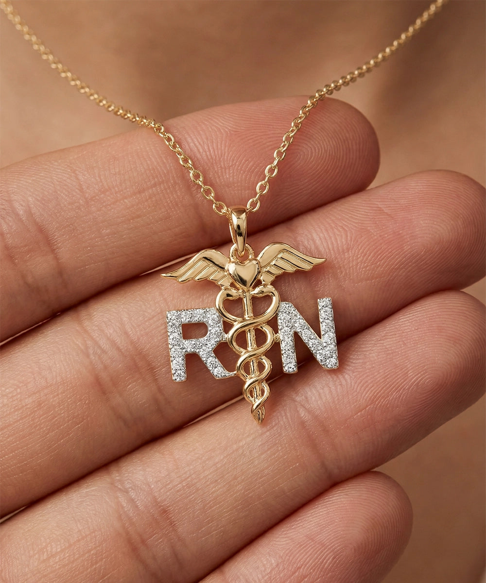 Gold necklace with 'RN' pendant held in a hand against a neutral background