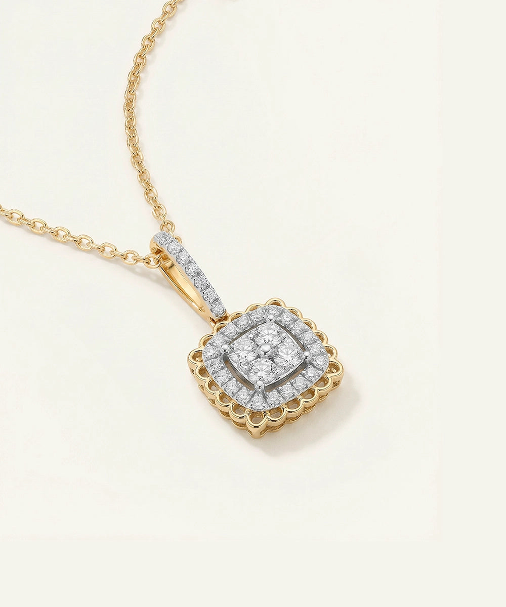 Gold necklace with a diamond pendant on a light beige background