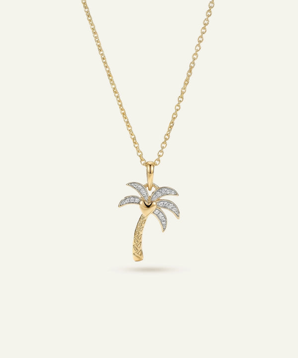 Gold palm tree pendant necklace on a white background