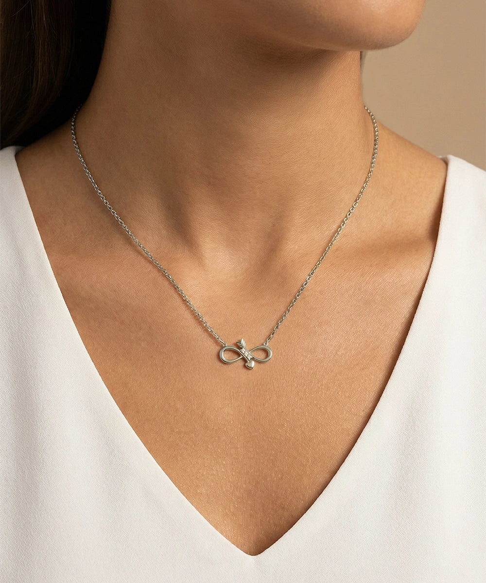 Necklace with a pendant worn by a person against a neutral background