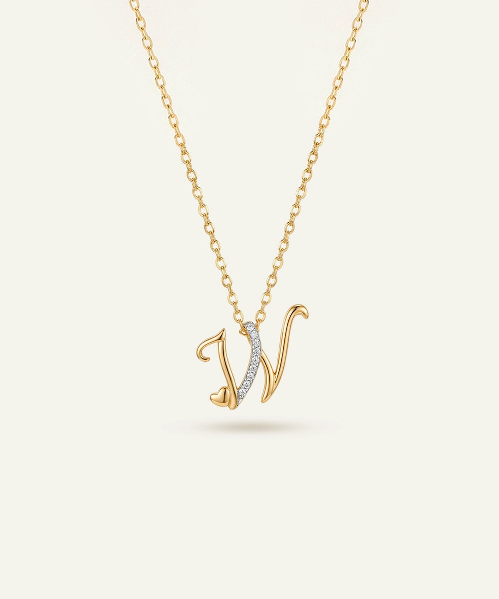 Gold necklace with a 'V' pendant on a light beige background