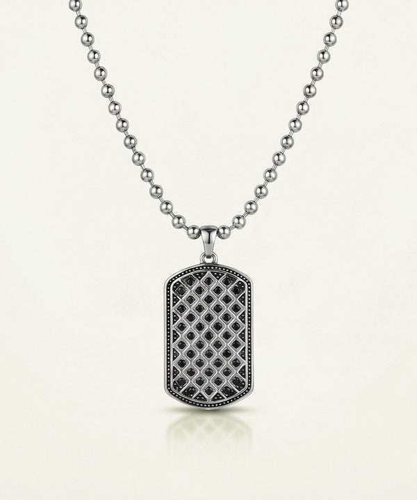 Silver necklace with a detailed pendant on a white background