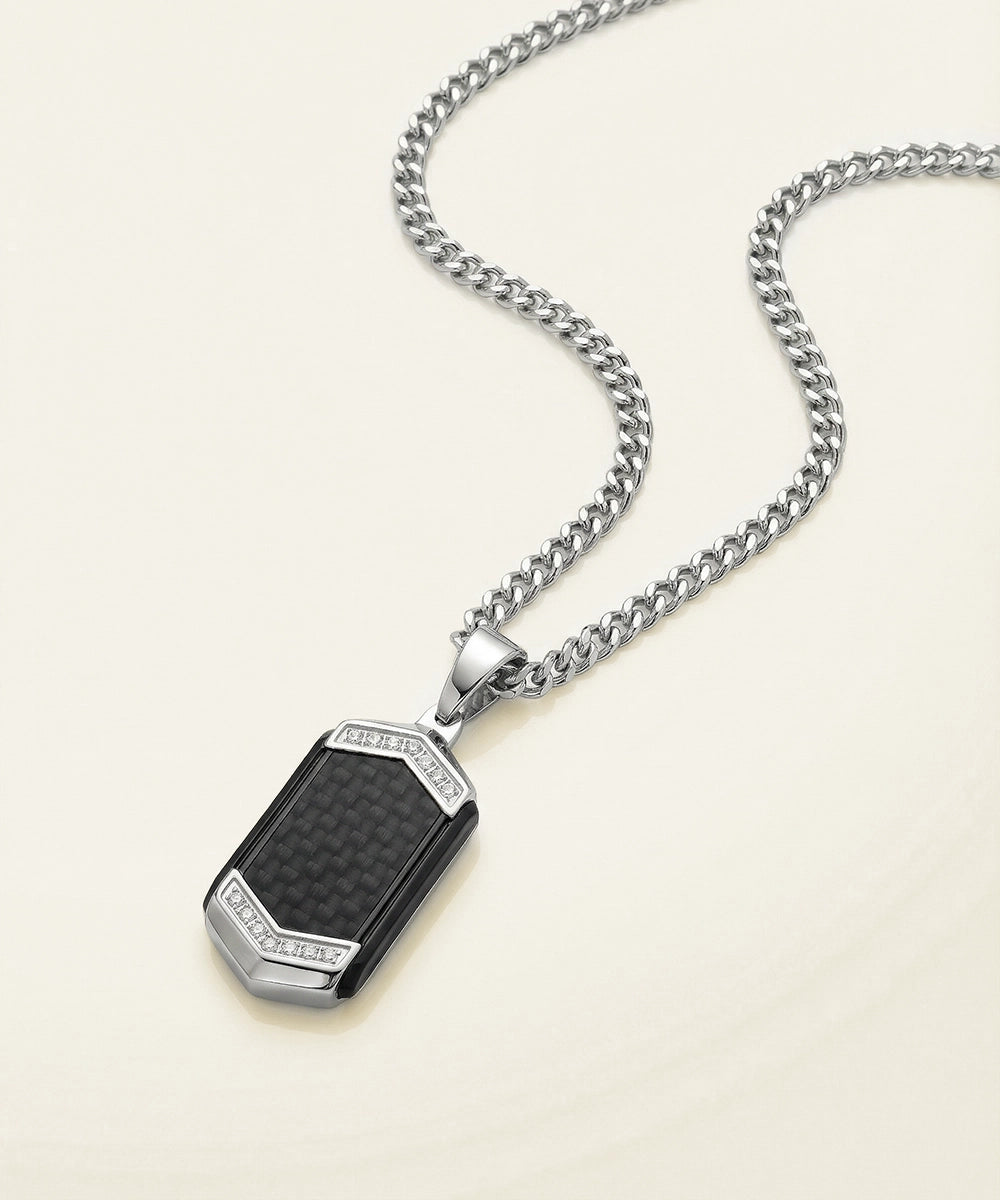 Silver necklace with a rectangular pendant on a beige background