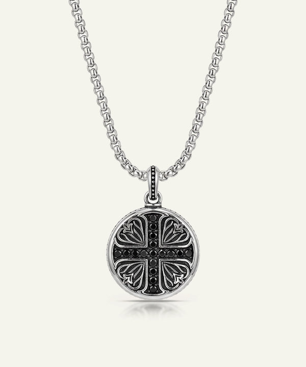 Silver necklace with a decorative pendant on a white background