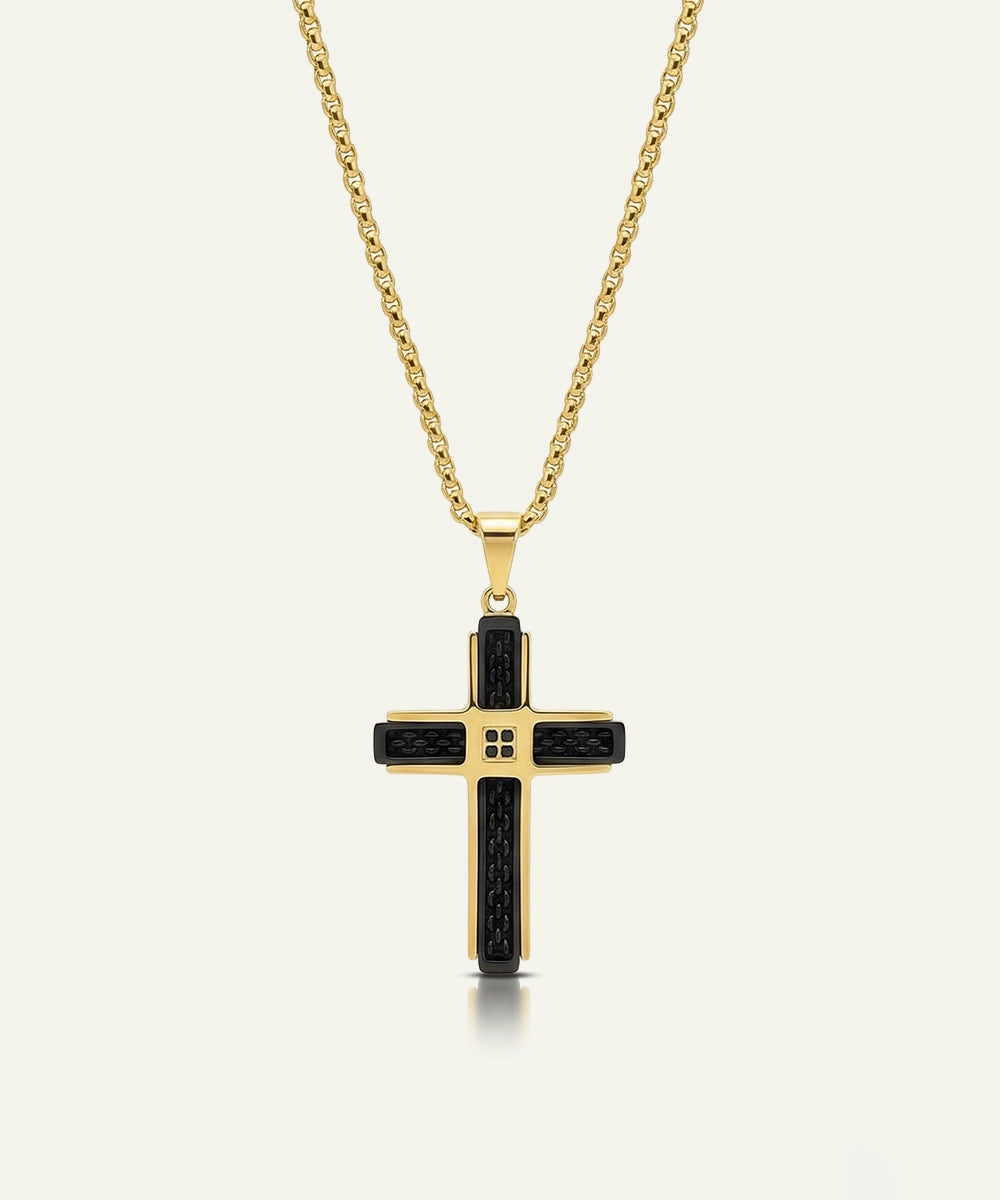 Gold cross pendant necklace with black accents on a white background