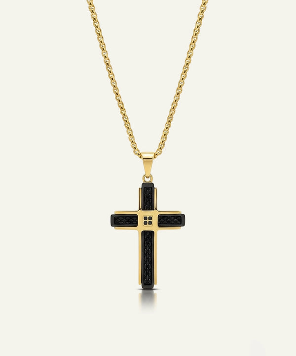 Gold cross pendant necklace with black accents on a white background