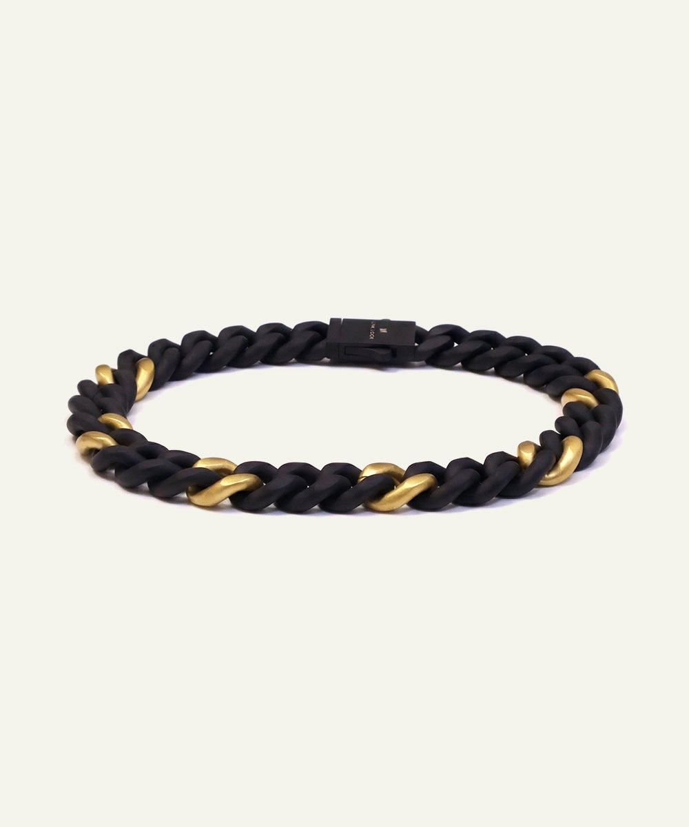 Black and gold braided bracelet on a white background