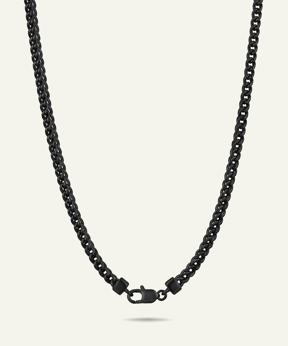 Black chain necklace on a light gray background