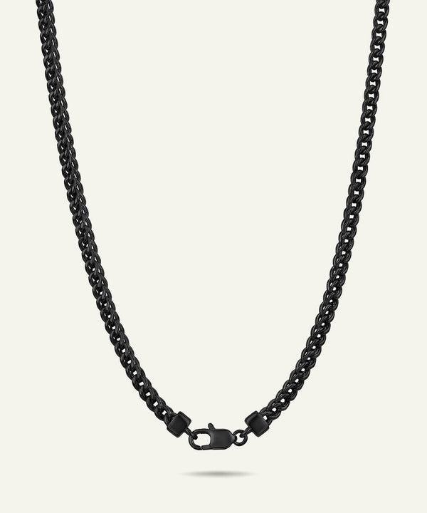 Black chain necklace on a light gray background
