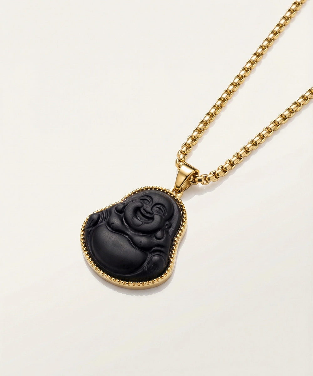 Gold necklace with black laughing Buddha pendant.