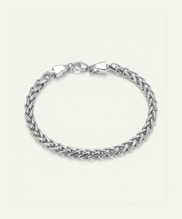 Silver braided bracelet on a light gray background
