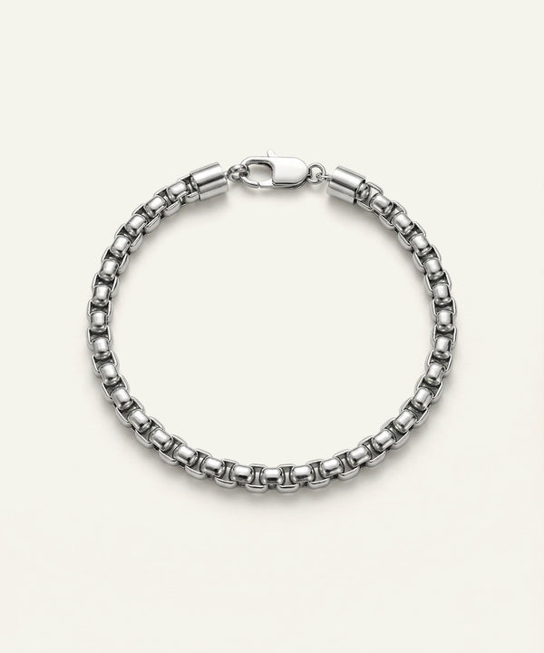 Silver bracelet on a light beige background