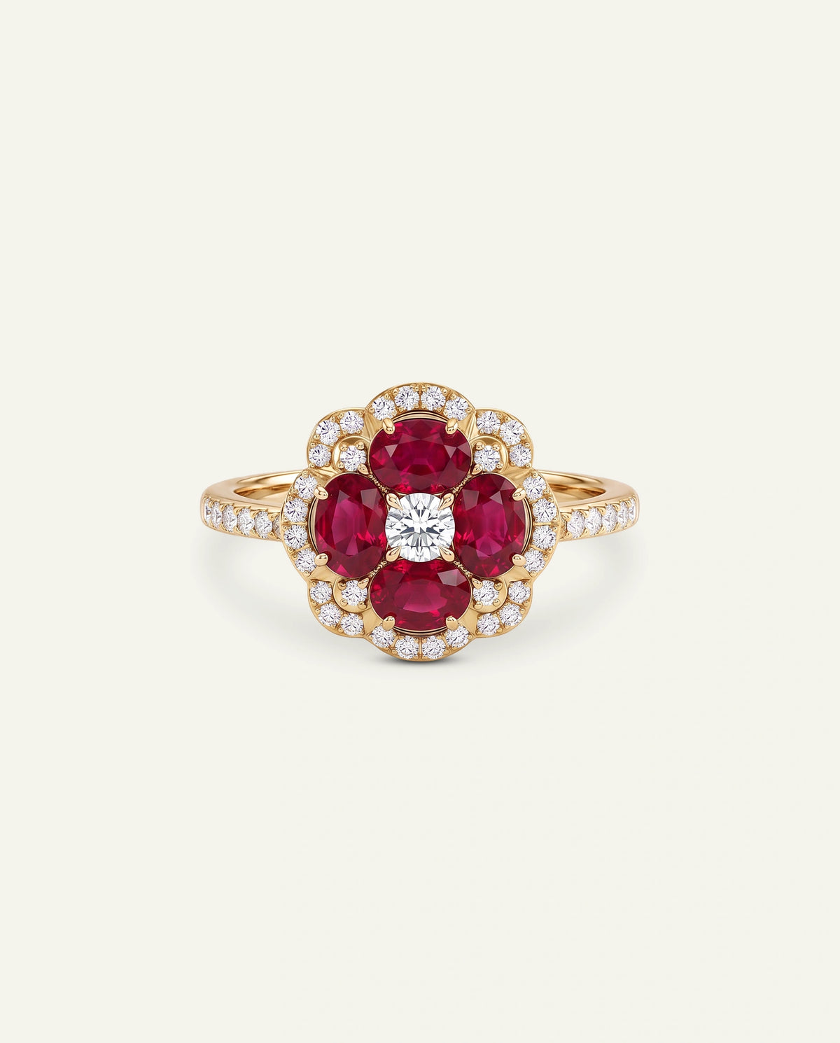 A yellow gold ring featuring a flower-shaped cluster with four round-cut deep red rubies, a central round clear diamond, and a halo of small clear stones, set against a light cream background.