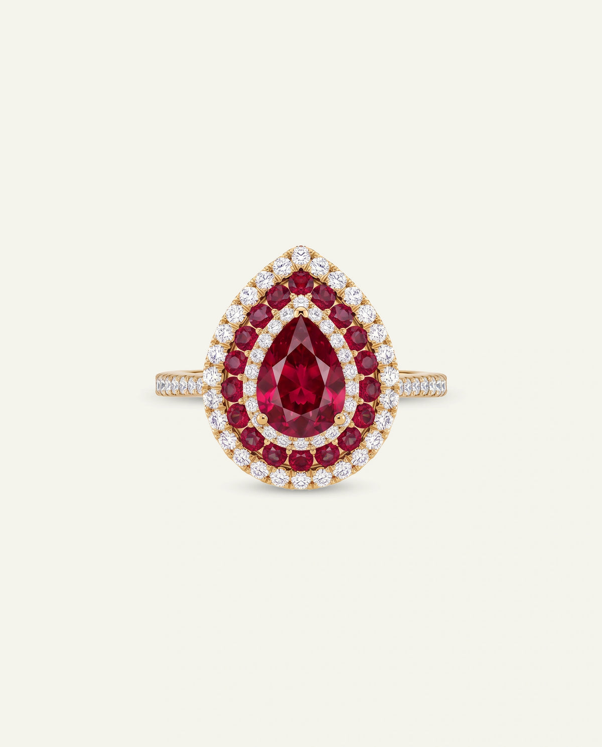 A teardrop-shaped ring featuring a central deep red ruby gemstone surrounded by a halo of smaller red rubies and clear diamonds, with a yellow gold band set with pavé diamonds, shown on a light cream background.
