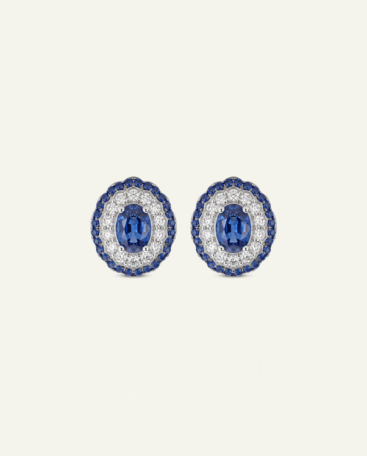 A pair of gold-toned dangle earrings with circular disc motifs, a central halo of clear stones, and a dangling white pearl bead on a clean white background.