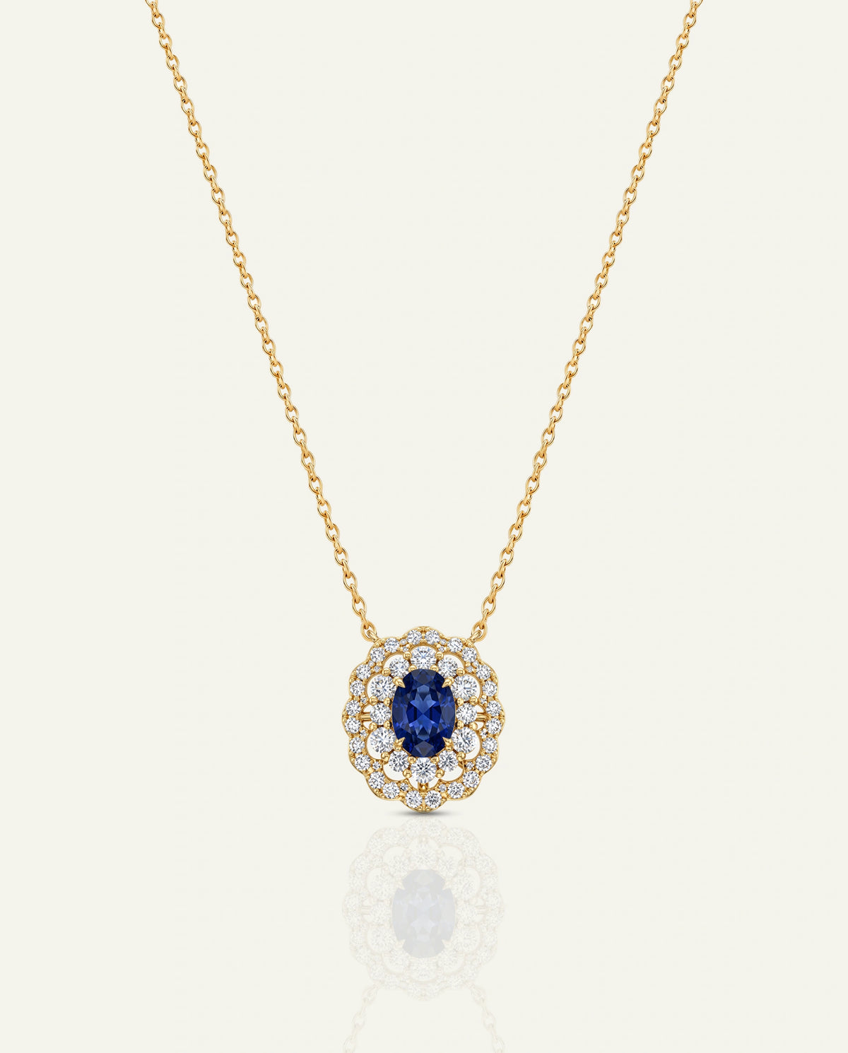 Gold star-shaped necklace with a brown center on a white background