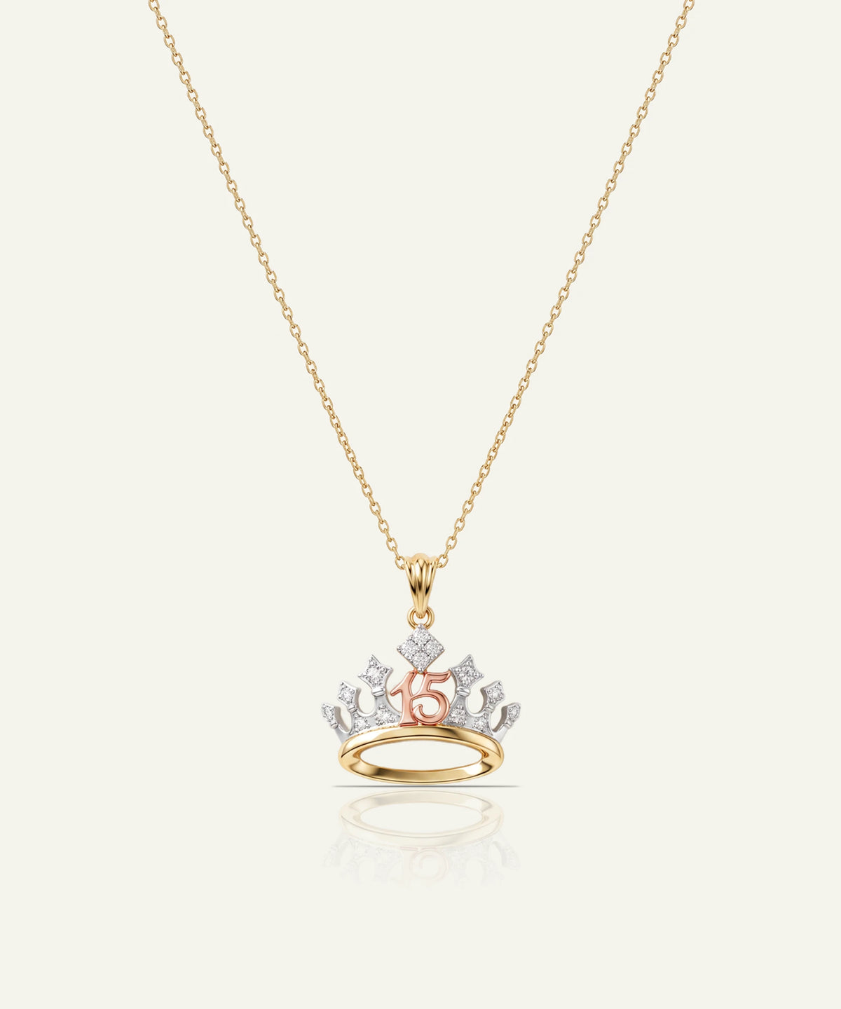 "Gold chain necklace with a crown pendant featuring a rose gold '15' and diamond accents."